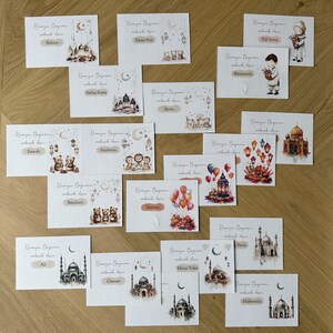 May include: A set of 16 cards with watercolor illustrations of mosques, lanterns, and stars. Each card has the text "Ramayan Bayrami" and a name, such as "Behice", "Exma Nur", and "Elif Serra".