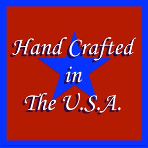 May include: A square graphic with a red background and a blue border. A blue star is in the center, with the words "Hand Crafted in The U.S.A." in white script.