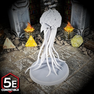 May include: A gray, 3D-printed miniature of a brain with tendrils, designed for tabletop gaming. The brain sits atop a round base, with the text "5E COMPATIBLE" in a red and white hexagon.