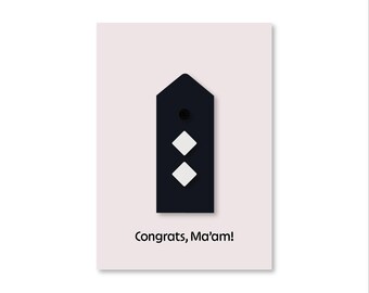 May include: A black and white card with a black rectangle containing two white diamonds and a black circle. The text "Congrats, Ma'am!" is printed below the rectangle.