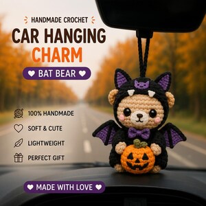 May include: A handmade crochet car hanging charm featuring a tan bear wearing a black bat costume with purple inner wings and ears. The bear has a purple bow tie and holds a small orange jack-o'-lantern. Text includes HANDMADE CROCHET CAR HANGING CHARM BAT BEAR.