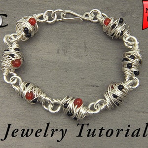 May include: A silver wire wrapped bracelet with red and black beads. The bracelet has a clasp closure. Jewelry Tutorial.