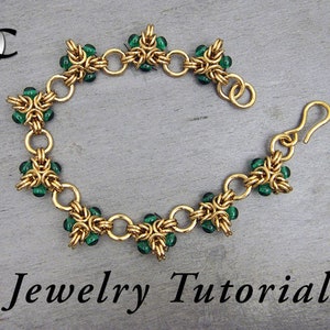 May include: Gold-toned bracelet with green beads, featuring a chainmail design. The bracelet has a hook clasp. The words "Jewelry Tutorial" are written in black script below the bracelet.