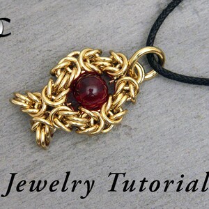 May include: Gold chainmail pendant with a red gemstone in the center, hanging from a black cord. Jewelry Tutorial.