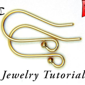 May include: Two gold earring hooks with a small ball at the end of each hook. Jewelry Tutorial.