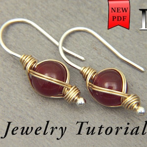 May include: A pair of silver earrings with red gemstone beads wrapped in gold wire. The earrings are a jewelry tutorial.
