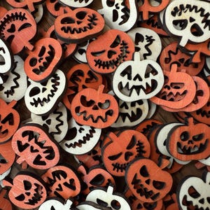 May include: A collection of wooden Halloween-themed cutouts. The assortment includes orange jack-o'-lanterns and white ghost-shaped figures. Each piece has a carved design, creating a festive and spooky aesthetic. Ideal for crafting or seasonal decor.