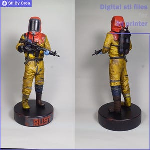 May include: A detailed figurine of a character in a yellow hazmat suit, holding a rifle. The figure has a red hood and a black respirator. The base is dark brown with the word "RUST" in orange. The image also contains the text "Digital stl files for printer".