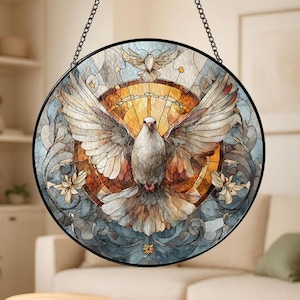 May include: Round stained glass window art featuring a dove with outstretched wings, set against a backdrop of warm orange and cool blue tones. The design includes floral accents and is framed by a black metal border, suspended by a chain.