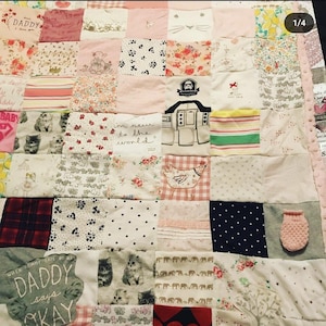 May include: A patchwork quilt made from various fabrics, including baby clothes. The quilt features a variety of patterns and colors, including pink, white, and blue. The quilt is made up of squares, each with a different design. The quilt is a great way to commemorate a baby's first year.