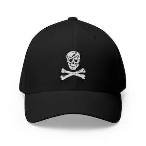 May include: Black baseball cap with a white embroidered skull and crossbones design. The cap has a curved brim and a structured fit. A classic accessory for casual wear.