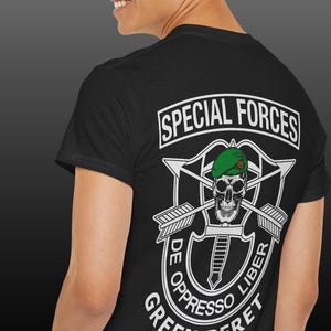 May include: Black t-shirt with a white graphic of the Special Forces insignia, including a skull, crossed arrows, and the words "Special Forces", "De Opresso Liber", and "Green Beret".