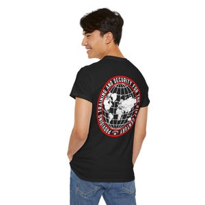 May include: Black t-shirt with a red circle graphic on the back. The graphic features a white globe with the text "Providing Training and Security for the 21st Century".