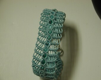 May include: A light blue crocheted bracelet with turquoise beads.