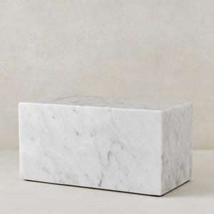 May include: A white marble rectangular block, perfect for displaying small items or as a decorative accent.