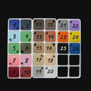 May include: A color swatch palette featuring twenty-six square tiles arranged in three white grids. Each tile displays a unique color, including shades of blue, green, pink, red, brown, gray, orange, yellow, and black, labeled with numbers 1 through 26.
