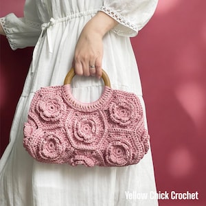 May include: A dusty pink crochet handbag featuring a textured floral pattern made of interconnected hexagonal motifs. The bag has a round, smooth wooden handle attached with matching pink yarn stitching. The text Yellow Chick Crochet is visible.