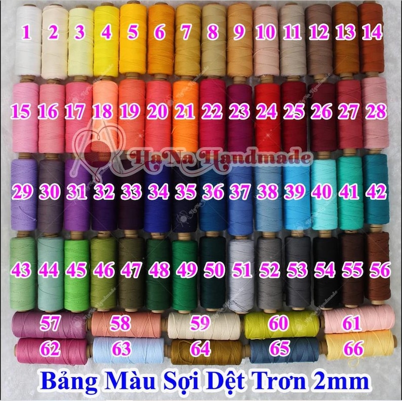 May include: A collection of 66 spools of 2mm round cord arranged in a grid, featuring a wide spectrum of colors including white, yellow, orange, pink, red, purple, blue, green, brown, and gray, with each spool labeled with a pink number.