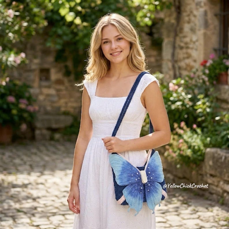 May include: A white sleeveless dress with a textured bodice and a crochet crossbody bag featuring a large, blue butterfly design with white pearl-like accents on the wings and a dark blue strap. The text YellowChickCrochet is visible.