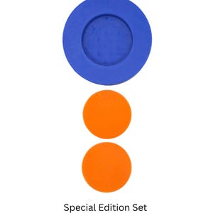 May include: A set of three round coasters. The top coaster is blue with a smaller blue circle in the center. The two bottom coasters are orange.