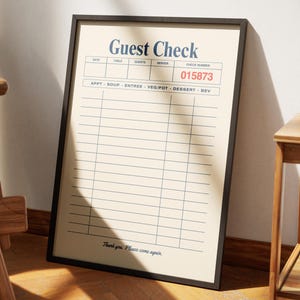 May include: A framed print of a vintage-style guest check. The beige background features a grid of lines for item entries. The header reads "Guest Check" in navy blue, with the check number "015873" in red. The bottom reads "Thank you. Please come again."