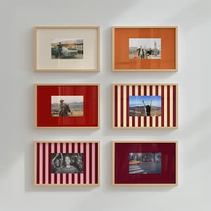 May include: Six rectangular picture frames with light wood borders, each containing a photograph and a mat. The mats feature solid colors including cream, orange, red, and dark red, as well as vertical striped patterns in red and cream.