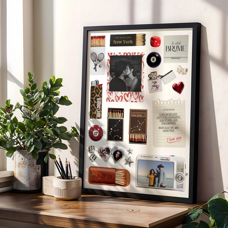 May include: A framed collage featuring various items: a photo, matches, a lighter with "EST. 2023", a pool ball, dice, and a camera. The collage includes the text "New York", "BRUME", and a note that says "I love you".