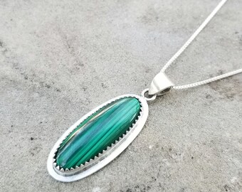 DILL - small oval malachite pendant, sterling silver with serrated edge bezel