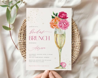 Puede incluir: Invitación a un brunch nupcial con un diseño de copa de champán, llena de burbujas y adornada con flores rosas y naranjas. El texto de la invitación dice "Brunch nupcial" e incluye detalles del evento.