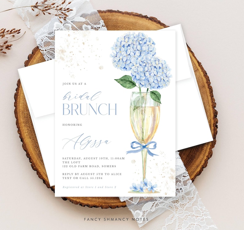 This beautiful design features delicate blue hydrangea flowers, in a gold champagne glass, perfect for your bridal shower or brunch celebration.