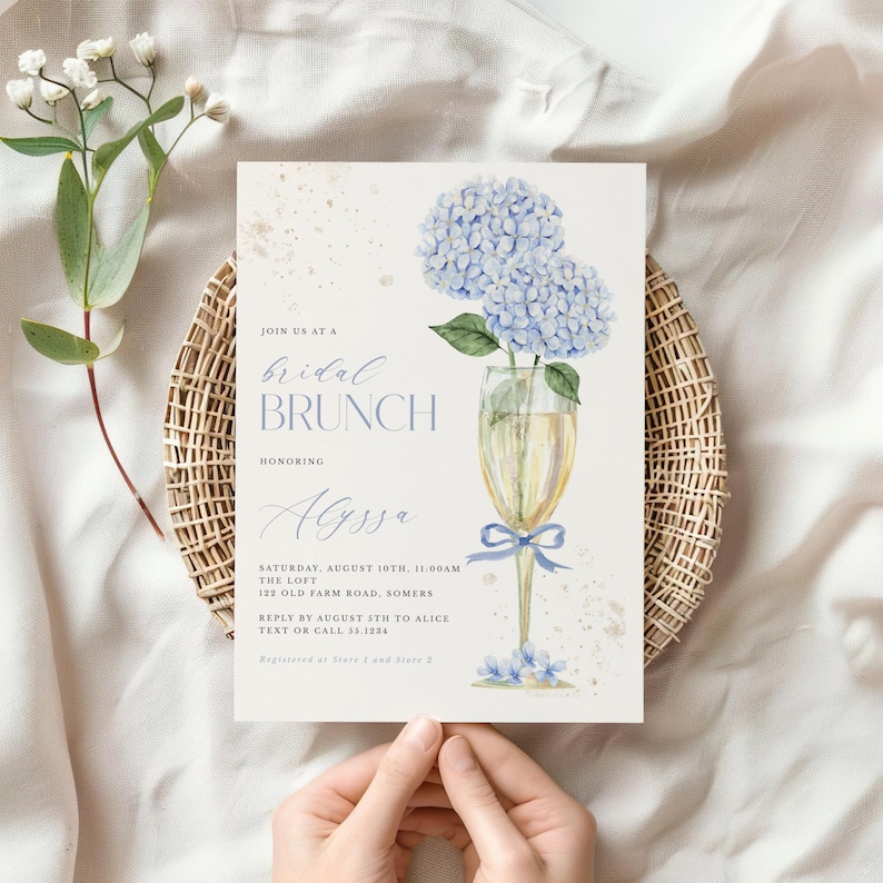 This beautiful design features delicate blue hydrangea flowers, in a gold champagne glass, perfect for your bridal shower or brunch celebration.