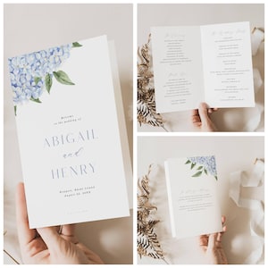 May include: Wedding stationery set with a floral design of blue hydrangeas and green leaves. The invitation includes the names Abigail and Henry, the wedding date and location. The set also includes a wedding program.
