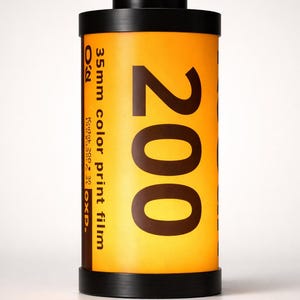May include: A cylindrical roll of 35mm color print film, labeled "200". The film canister is primarily yellow with black text and accents. The top and bottom are black. The film is labeled "Kodak 200" and "EXP."
