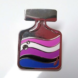 May include: A silver-toned metal pin shaped like a bottle with a blue, black, purple, white, and pink striped design. The pin has a silver-toned top and a silver-toned back.