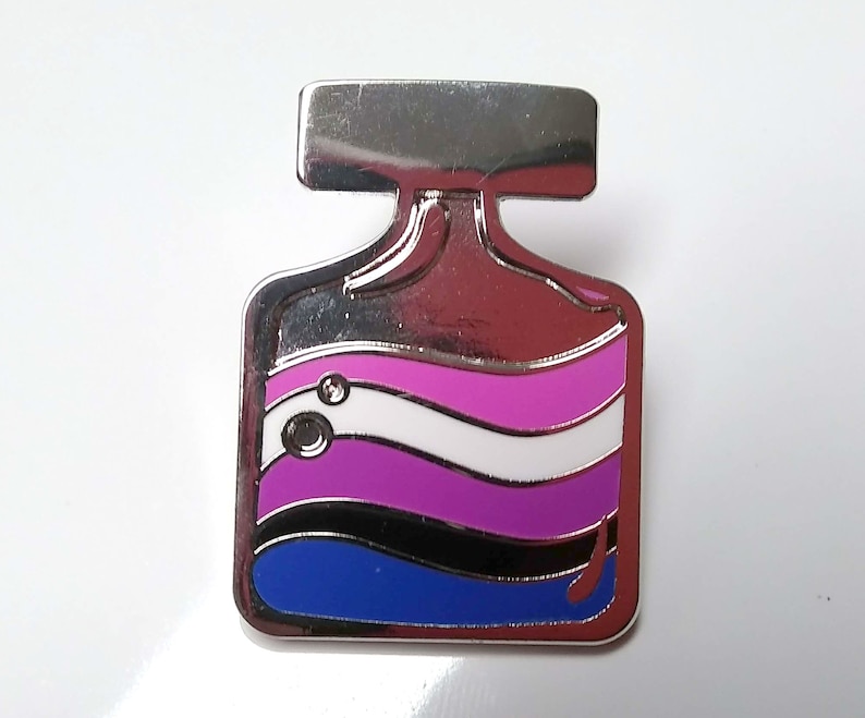 May include: A silver-toned metal pin shaped like a bottle with a blue, black, purple, white, and pink striped design. The pin has a silver-toned top and a silver-toned back.