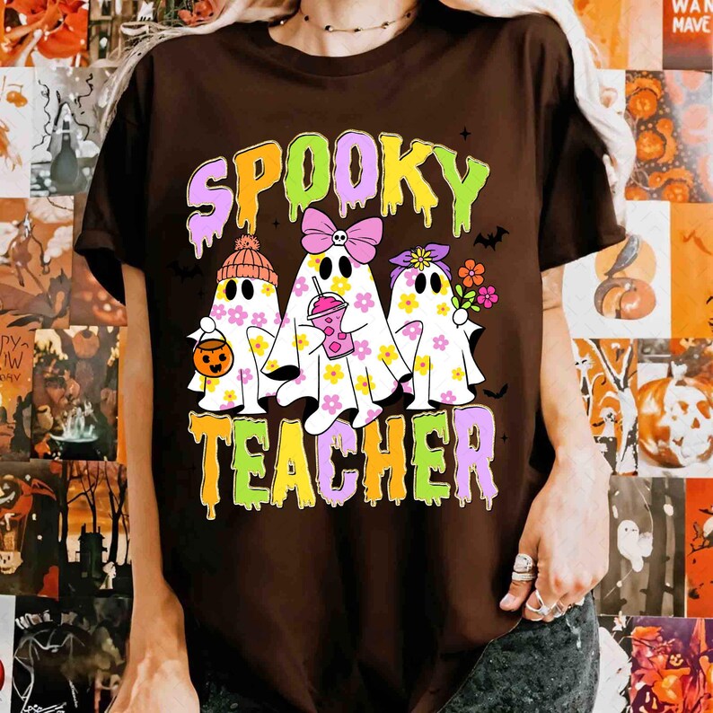 May include: A brown t-shirt with the words "Spooky Teacher" in a colourful, layered font. The shirt features three ghost characters decorated with flowers, bows, and accessories, perfect for Halloween.