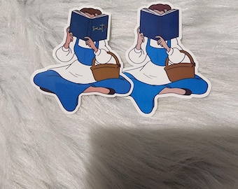 Puede incluir: Dos pegatinas de una mujer de dibujos animados con un vestido azul y sosteniendo una cesta. Está leyendo un libro que dice "Sweet" en la portada.