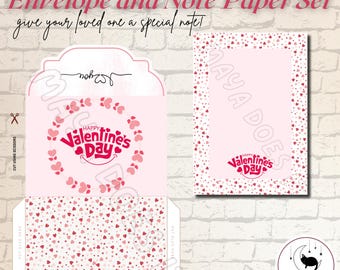 Op de afbeelding: Roze envelop en briefpapierset met een hartjespatroon en de tekst "Happy Valentine's Day".