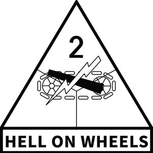 以下が含まれることがあります： 上部に数字の2がある三角形の白黒グラフィック。三角形の中には、稲妻のある戦車があります。「HELL ON WHEELS」という言葉が下にあります。