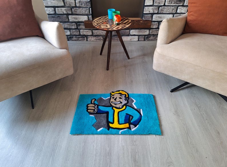 May include: A blue and gray rug with a cartoon character on it. The character is a man with yellow hair and a blue jumpsuit. He is giving a thumbs up. The rug is on a light gray floor.