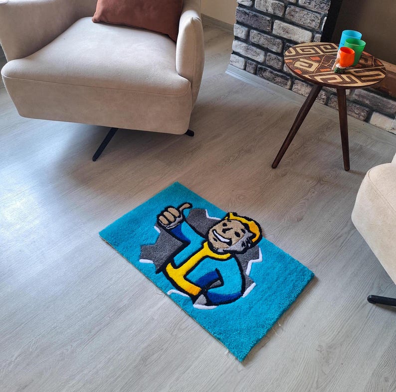 May include: A blue and yellow rug with a cartoon character on it. The character is wearing a blue jumpsuit and a yellow hard hat. The character is giving a thumbs up. The rug is on a light wood floor.