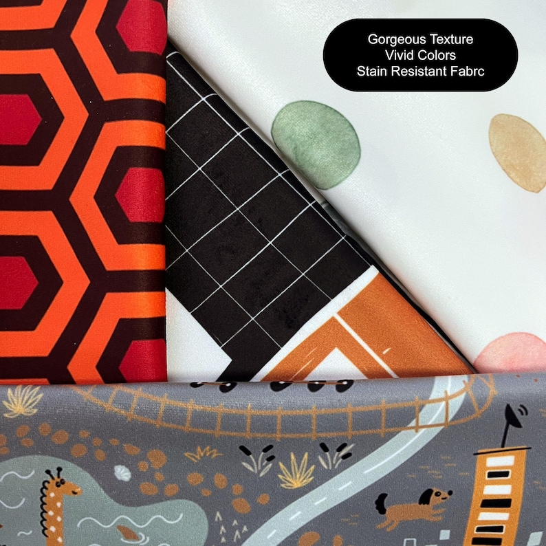 May include: Three fabric swatches with different patterns. The first is a red and black geometric pattern. The second is a black and white grid pattern with a brown and orange geometric pattern on top. The third is a white fabric with green, brown, and pink watercolor dots. The text "Gorgeous Texture Vivid Colors Stain Resistant Fabric" is printed on the third swatch.