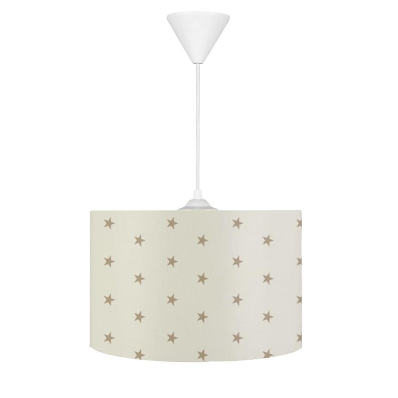 May include: A white ceiling light fixture with a beige drum shade featuring a pattern of brown stars.