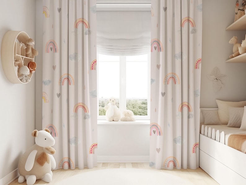 May include: A pair of white curtains with a rainbow and heart pattern. The curtains are hung in a nursery with a white crib and a stuffed animal.