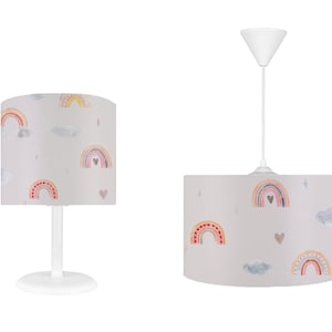 May include: Two white pendant lights with a grey fabric shade featuring a rainbow and heart pattern.