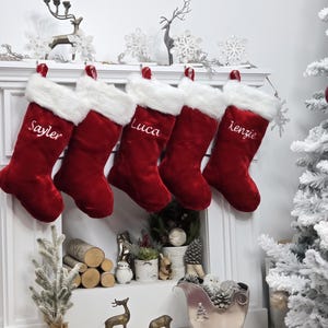 This luxurious plush 21'' Christmas stocking is a deep burgundy color with faux fox fur trim.