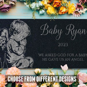 May include: Black granite memorial plaque with a silver angel baby image, the text "Baby Ryan 2023" and the quote "We asked God for a baby. He gave us an angel."