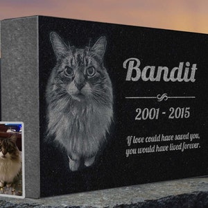 May include: Black granite pet memorial with a photo of a cat engraved on it. The text "Bandit 2001-2015" is engraved below the photo. The text "If love could have saved you, you would have lived forever." is engraved below the dates.