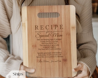 May include: A wooden cutting board with a recipe for a special mom engraved on it. The recipe includes ingredients like patience, courage, love, generosity, laughter, and understanding. The board is held by a person's hands.