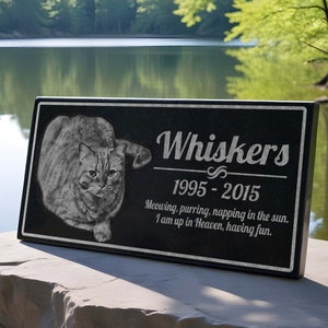 May include: Black granite pet memorial plaque with a photo of a tabby cat and the text "Whiskers 1995-2015 Meowing, purring, napping in the sun. I am up in Heaven, having fun."
